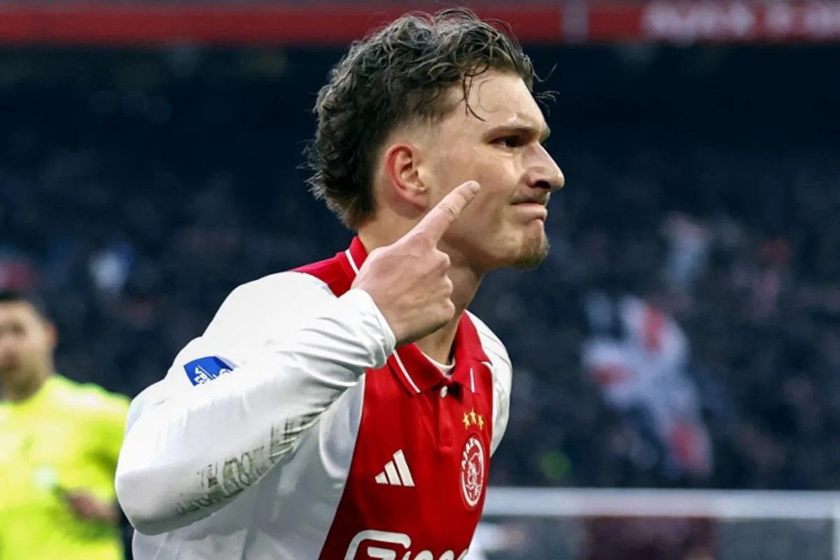 Ajax's Belgian forward #11 Mika Godts celebrates after scoring his team's first goal during the Dutch Eredivisie football match between Ajax Amsterdam and Heracles Amelo at the Johan Cruijff ArenA in Amsterdam on February 16, 2025. MAURICE VAN STEEN / ANP / AFP