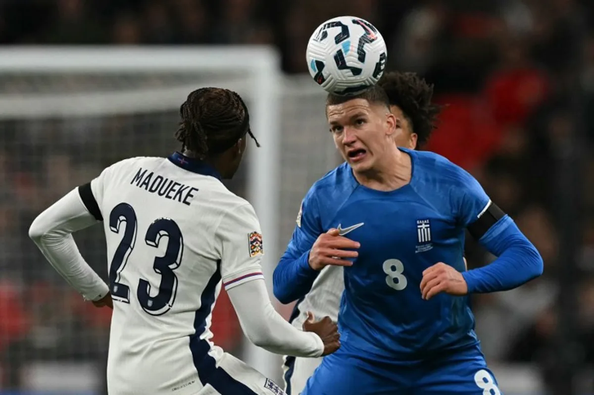 Greece's striker #08 Christos Tzolis (R) vies with England's striker #23 Noni Madueke (L) during the UEFA Nations League, League B - Group 2, football match between England and Greece at Wembley Stadium in London on October 10, 2024.   Glyn KIRK / AFP