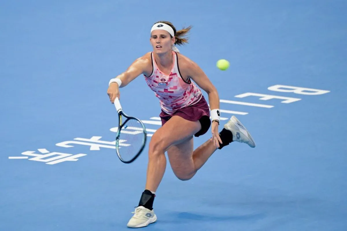 Belgium's Greet Minnen hits a return to China's Zhang Shuai during their women's singles match at the China Open tennis tournament in Beijing on September 29, 2024.  Jade Gao / AFP