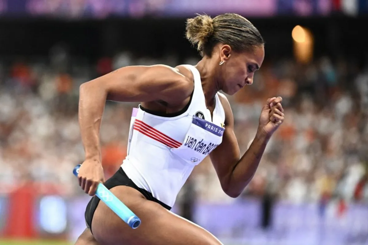 Belgium's Naomi Van Den Broeck takes the start in the women's 4x400m relay final of the athletics event at the Paris 2024 Olympic Games at Stade de France in Saint-Denis, north of Paris, on August 10, 2024.  Jewel SAMAD / AFP