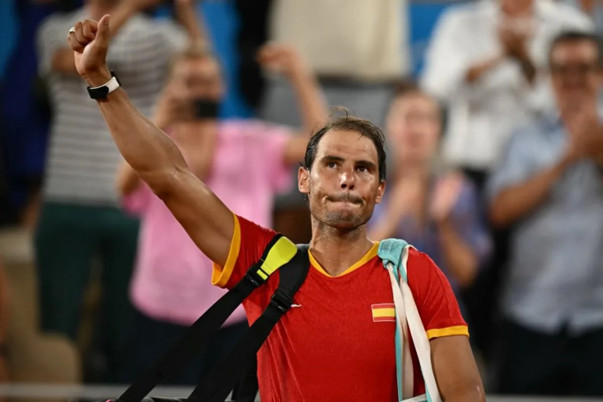 Spain's Rafael Nadal waves goodbye after he and Spain's Carlos Alcaraz  lose to US' Austin Krajicek and US' Rajeev Ram in their men's doubles quarter-final tennis match on Court Philippe-Chatrier at the Roland-Garros Stadium during the Paris 2024 Olympic Games, in Paris on July 31, 2024.   CARL DE SOUZA / AFP