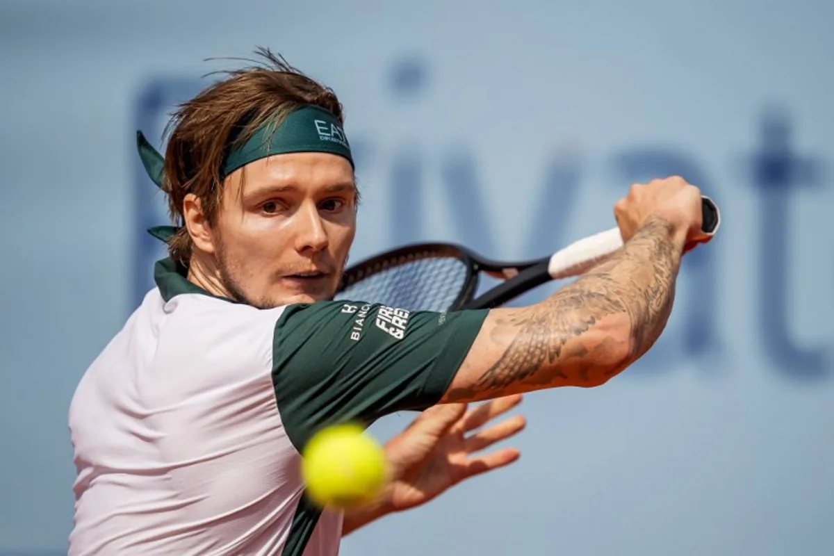 Kazakhstan's Alexander Bublik returns the ball to Argentina's Juan Manuel Cerundolo during their men's singles final match at the Swiss Open tennis tournament in Gstaad, on July 20, 2025. Fabrice COFFRINI / AFP