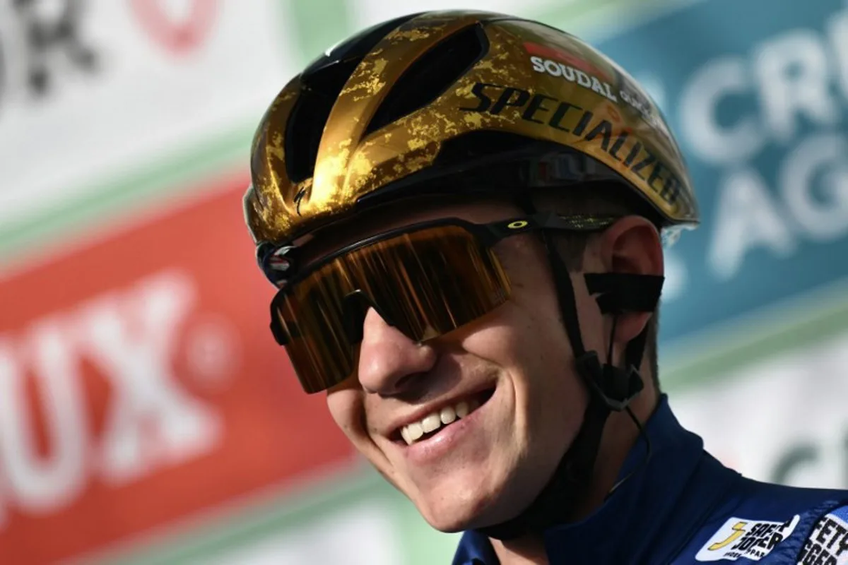 Soudal Quick-Step team's Belgian rider Remco Evenepoel looks on from the presentation podium before the start of 118th edition of the Giro di Lombardia (Tour of Lombardy), a 252km cycling race from Bergamo to Como on October 12, 2024.  Marco BERTORELLO / AFP