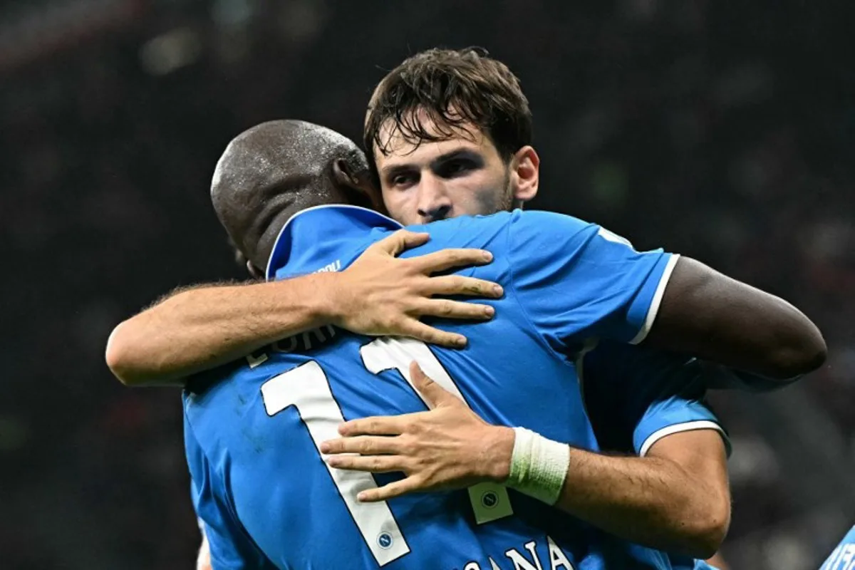 Napoli's Georgian forward #77 Khvicha Kvaratskhelia celebrates scoring his team's second goal with Napoli's Belgian forward #11 Romelu Lukaku, during the Italian Serie A football match Ac Milan vs Napoli at San Siro Meazza stadium in Milan on October 29, 2024.  Gabriel BOUYS / AFP