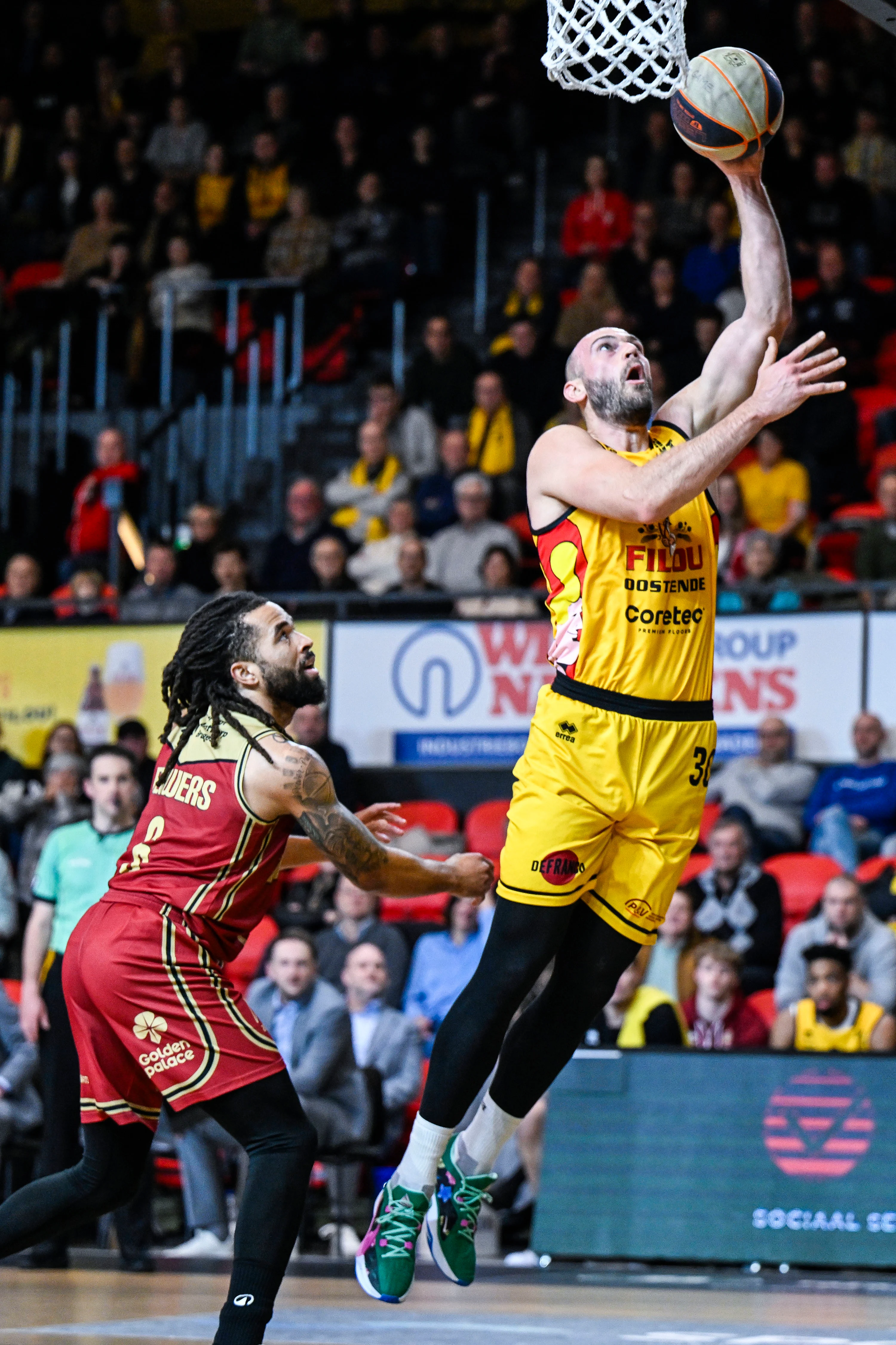 Antwerp's Michael Flowers and Oostende's Pierre-Antoine Gillet pictured in action during a basketball match between Filou Oostende and Antwerp Giants, Thursday 13 February 2025 in Oostende, the return leg of the semi-finals of the men's Belgian Basketball Cup. BELGA PHOTO TOM GOYVAERTS