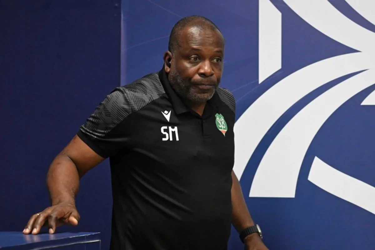 Suriname's head coach Stanley Menzo arrives for a press conference at Manuel Felipe Carrera stadium in Guatemala City on November 17, 2025, ahead of the FIFA World Cup 2026 qualifier football match against Guatemala.  JOHAN ORDONEZ / AFP