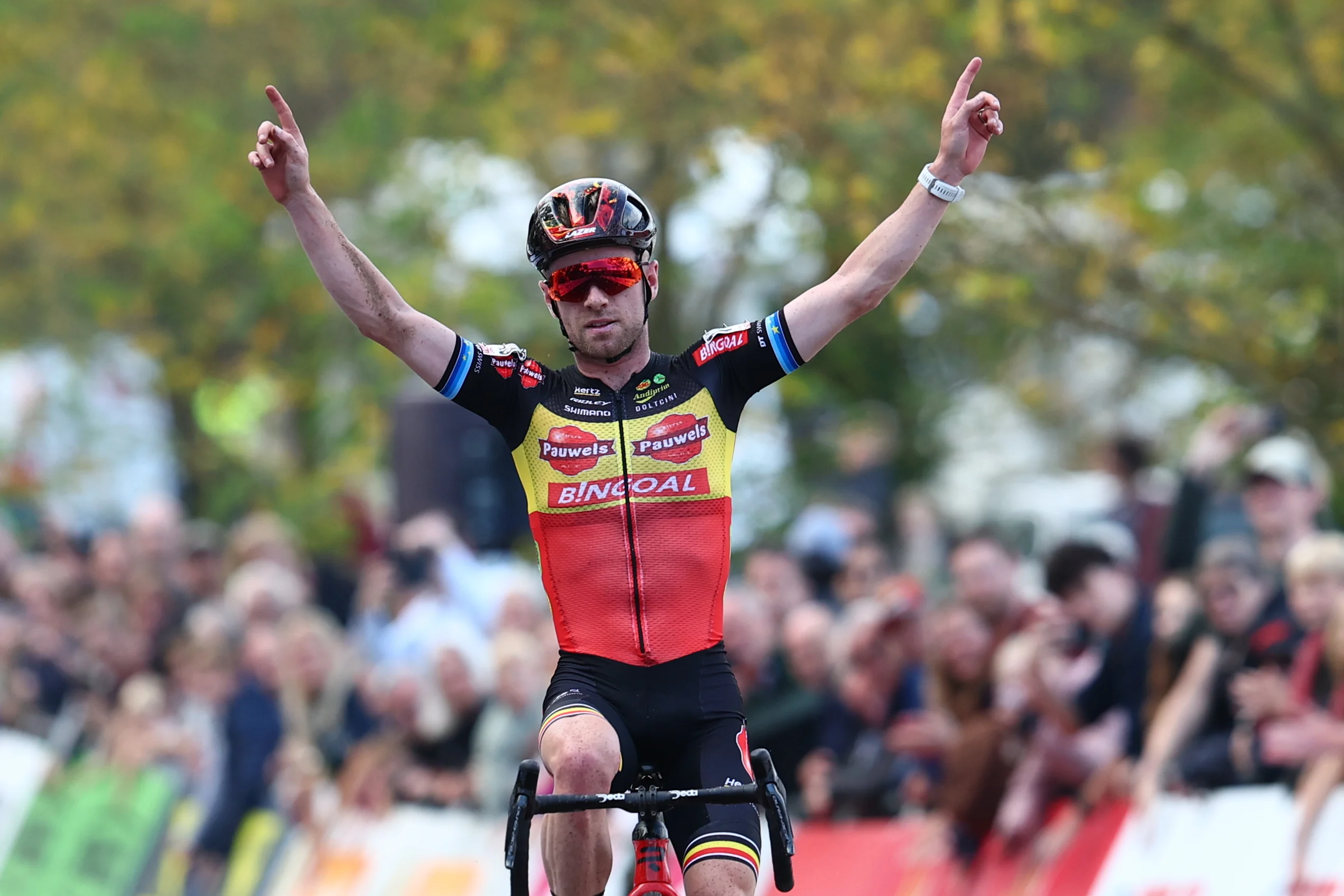 Belgian Eli Iserbyt celebrates as he crosses the finish line at the men's elite race of the Exact Cross, stage 3 (out of 7) in the Exact Cross cyclocross competition, in Heerderstrand, Netherlands, Saturday 26 October 2024. BELGA PHOTO DAVID PINTENS