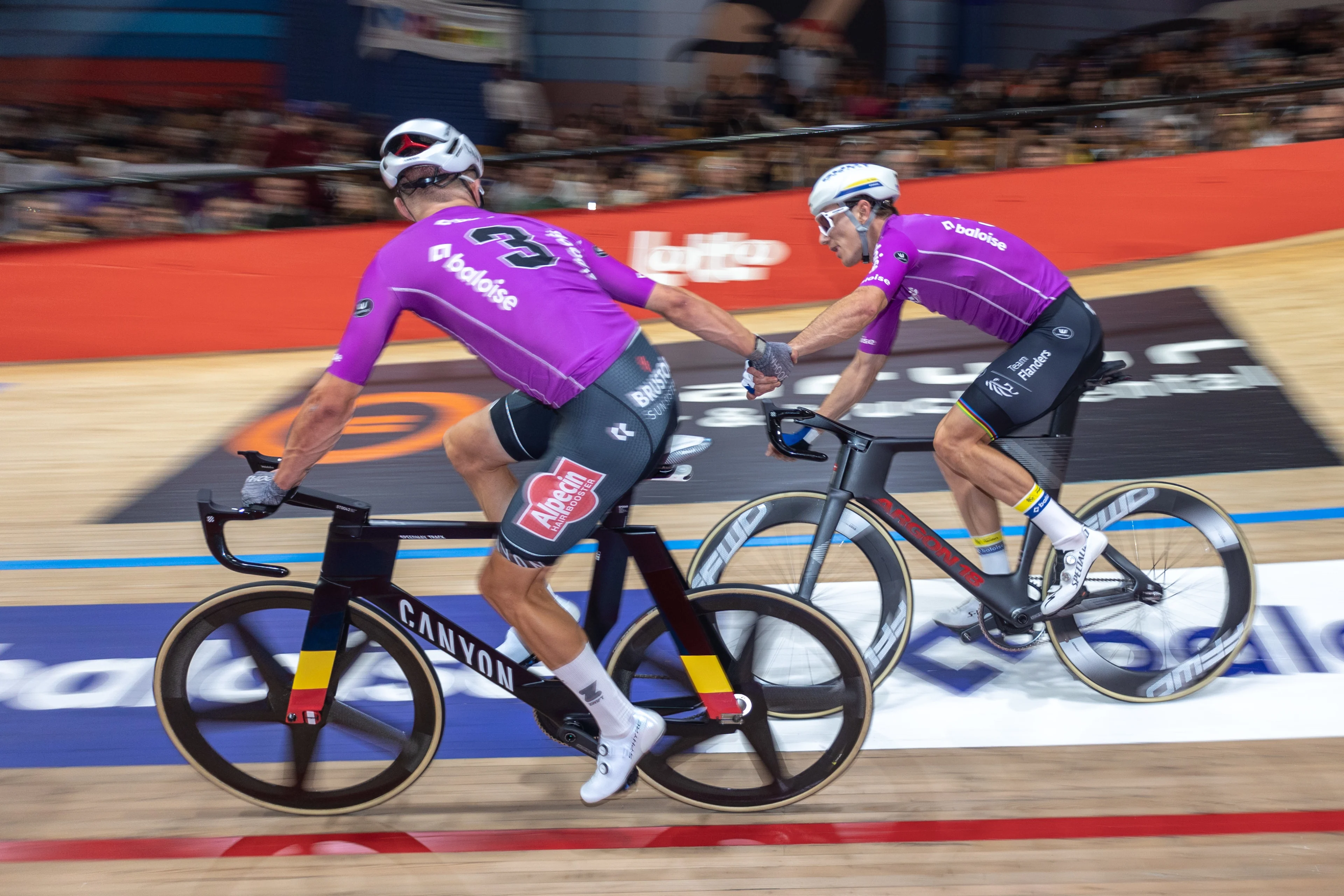 Belgian Lindsay De Vylder and Belgian Robbe Ghys pictured in action during the first day of the Zesdaagse Vlaanderen-Gent six-day indoor track cycling event at the indoor cycling arena 't Kuipke, Tuesday 12 November 2024, in Gent. BELGA PHOTO WARD VANDAEL