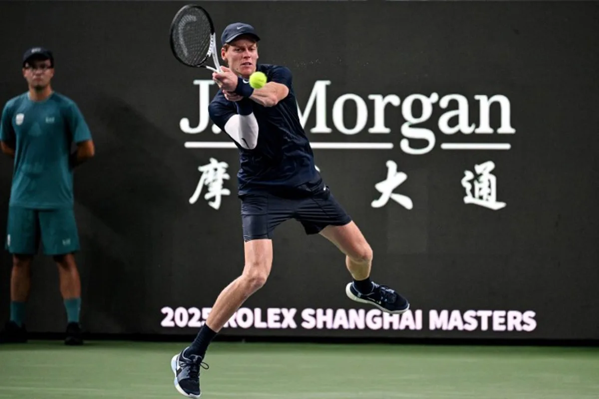 Italy's Jannik Sinner hits a return to Netherlands' Tallon Griekspoor during their men's singles match at the Shanghai Masters tennis tournament in Shanghai on October 5, 2025. Hector RETAMAL / AFP