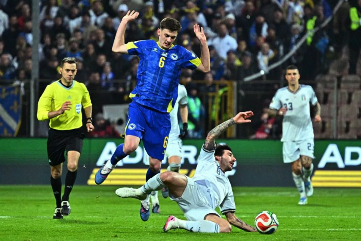 Bosnia-Herzegovina's midfielder #06 Benjamin Tahirovic (L) fights for the ball with Italy's midfielder #08 Sandro Tonali during the FIFA World Cup 2026 European qualification final football match between Bosnia-Herzegovina and Italy at the Bilino-Polje stadium in Zenica on March 31, 2026.   Elvis BARUKCIC / AFP