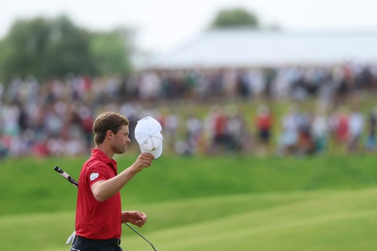 Belgium's Thomas Detry gestures after completing the course in round 4 of the men's golf individual stroke play of the Paris 2024 Olympic Games at Le Golf National in Guyancourt, south-west of Paris on August 4, 2024.   Emmanuel DUNAND / AFP