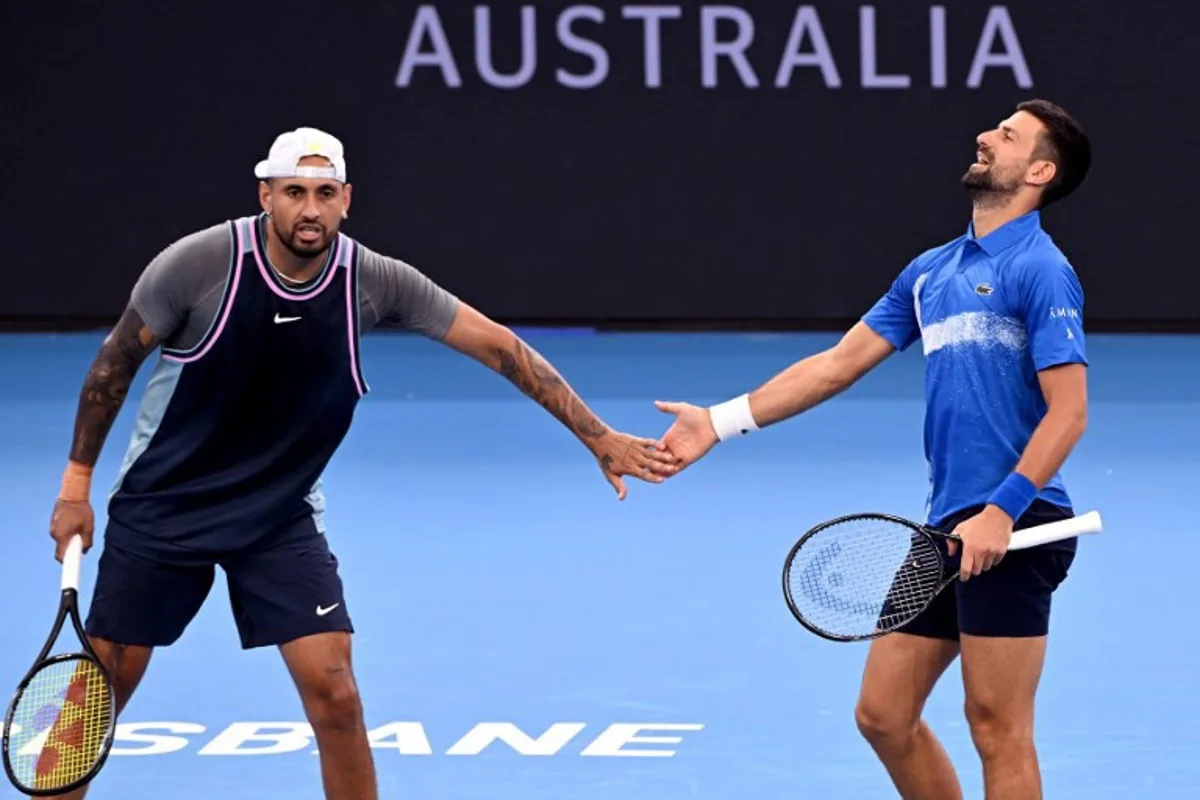 Novak Djokovic of Serbia (R) and Nick Kyrgios of Australia react during their men's doubles match against Michael Venus of New Zealand and Nikola Mektic of Croatia at the Brisbane International tennis tournament in Brisbane on January 1, 2025.  William WEST / AFP