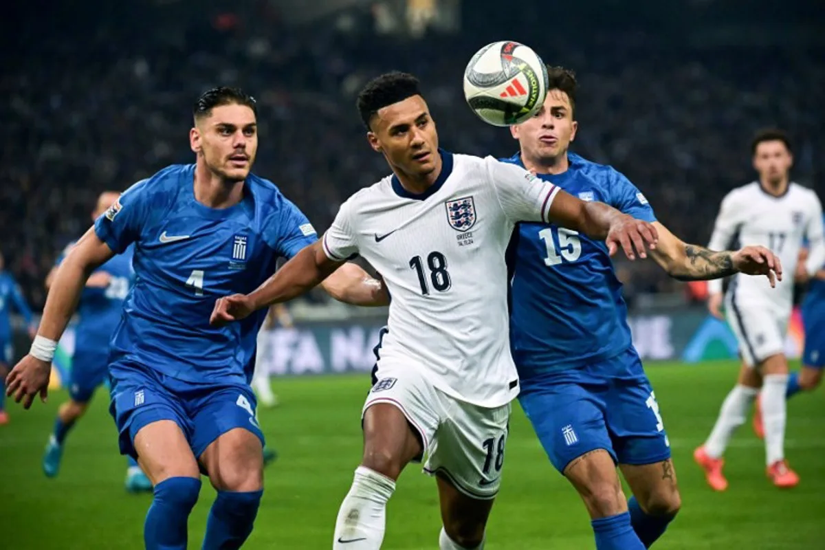 England's forward #18 Ollie Watkins (C) fights for the ball with Greece's defender #15 Lazaros Rota (R) during the UEFA Nations League, League B group B2 football match between Greece and England at Olympic Athletic Center of Athens "Spyros Louis" stadium in Athens, on November 14, 2024.  Aris MESSINIS / AFP