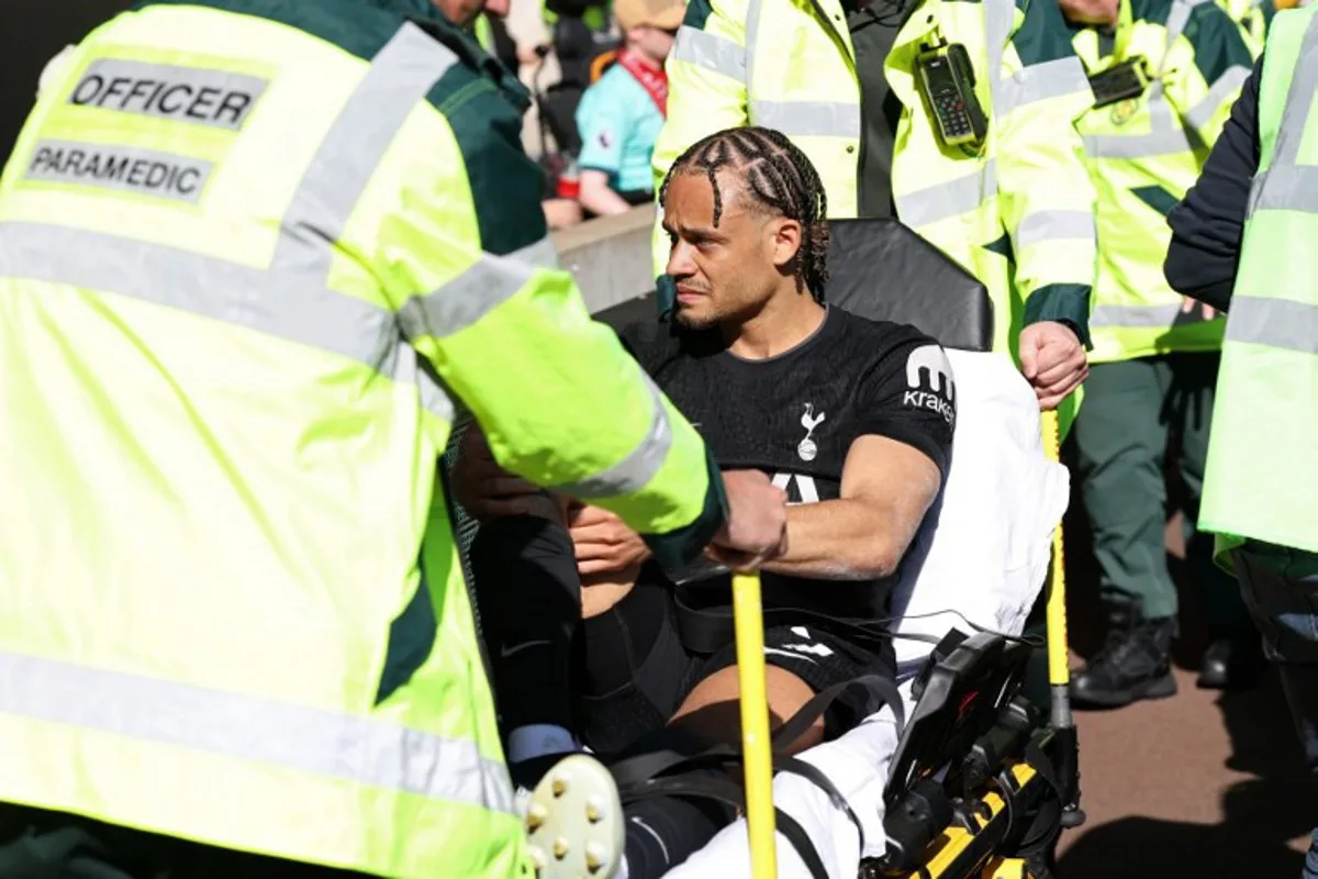 Tottenham Hotspur's Dutch midfielder #07 Xavi Simons is taken off on a stretcher during the English Premier League football match between Wolverhampton Wanderers and Tottenham Hotspur at the Molineux stadium in Wolverhampton, central England on April 25, 2026.  Darren Staples / AFP