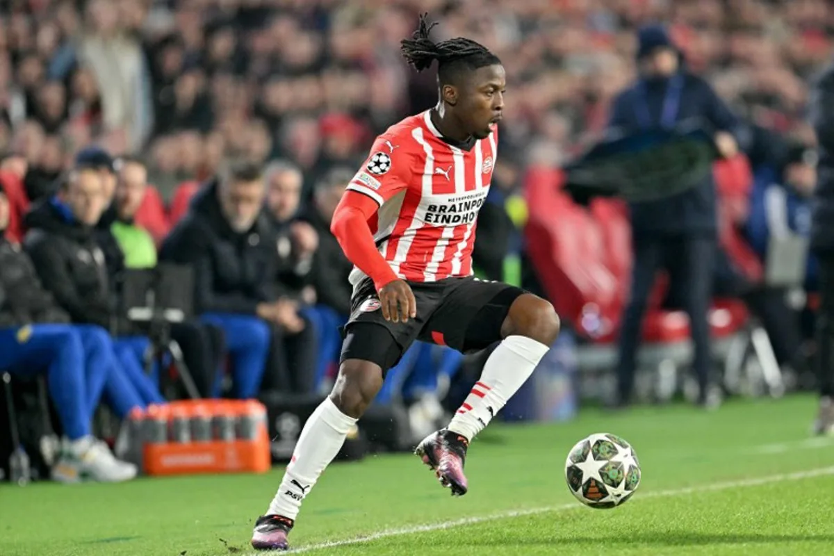 PSV Eindhoven's Belgian forward #11 Johan Bakayoko drives the ball during the UEFA Champions League knockout phase play-off 2nd leg football match between PSV Eindhoven and Juventus at the Philips Stadion in Eindhoven on February 19, 2025.  NICOLAS TUCAT / AFP