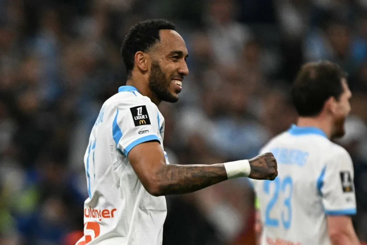 Marseille's Gabonese forward #17 Pierre-Emerick Aubameyang celebrates scoring his team's third goal during the French L1 football match between Olympique de Marseille (OM) and Stade Rennais FC at the Stade Velodrome in Marseille, southern France, on May 17, 2026. Gabriel BOUYS / AFP