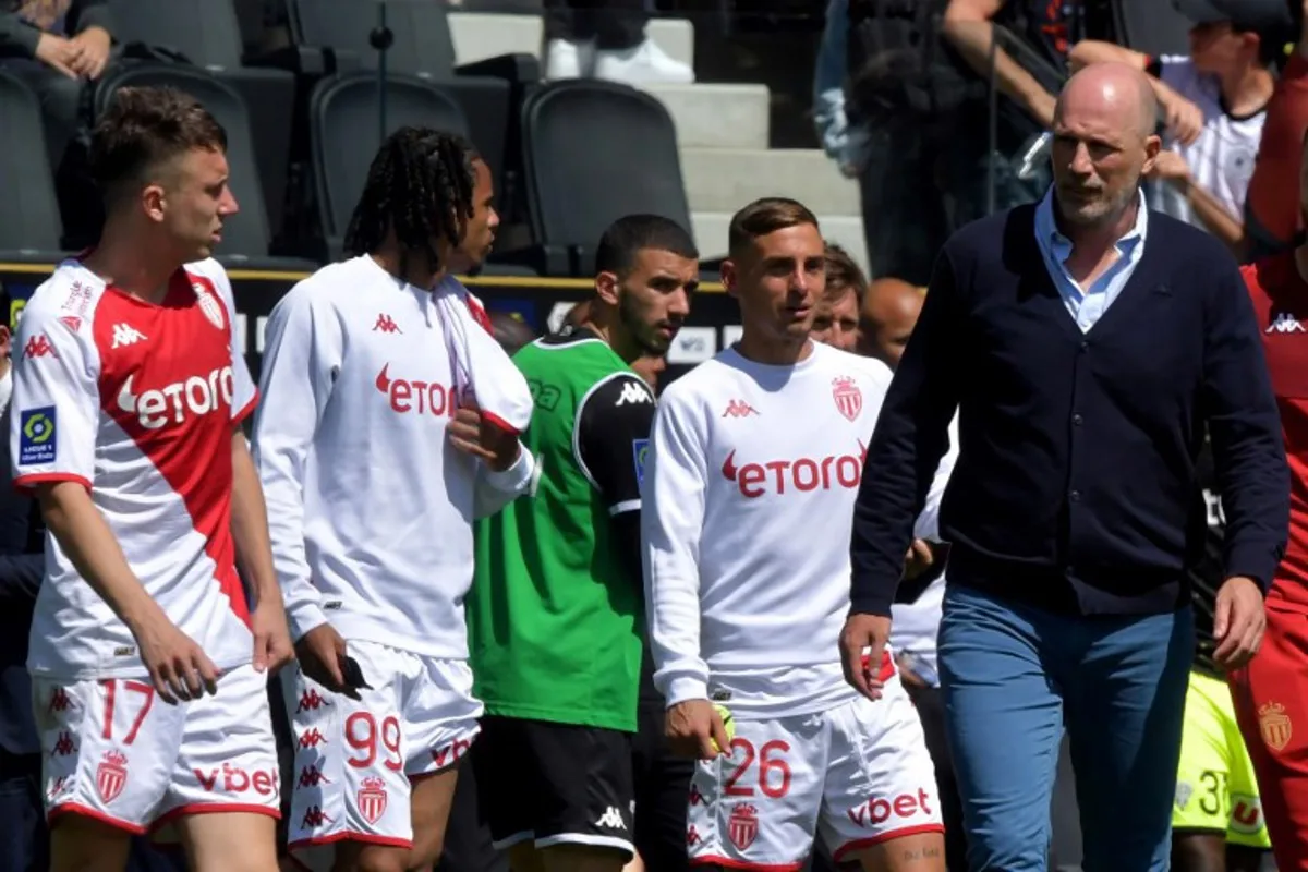 Monaco's Russian midfielder Aleksandr Golovin (L), Monaco's French defender Yllan Okou (2nd-L) and Monaco's Belgian head coach Philippe Clement (R) are pictured at the end of the French L1 football match between SCO Angers and AS Monaco at The Raymond-Kopa Stadium in Angers, western France on May 7, 2023. JEAN-FRANCOIS MONIER / AFP