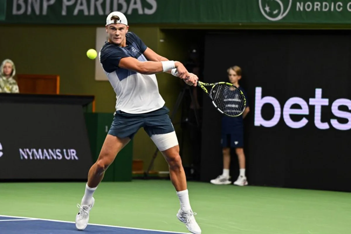 Denmark's Holger Rune returns the ball to France's Ugo Humbert (not in Picture) during the semi-final of the BNP Paribas Nordic Open tennis tournament at the Royal Swedish Tennis Hall in Stockholm, Sweden, on October 18, 2025. Anders WIKLUND / TT NEWS AGENCY / AFP