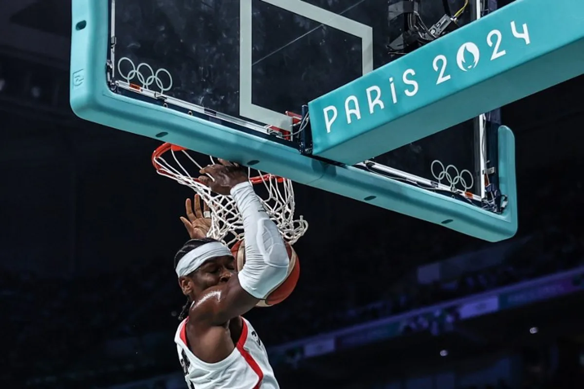 Canada's #02 Shai Gilgeous-Alexander dunks the ball in the men's preliminary round group A basketball match between Canada and Spain during the Paris 2024 Olympic Games at the Pierre-Mauroy stadium in Villeneuve-d'Ascq, northern France, on August 2, 2024.  Sameer AL-DOUMY / AFP