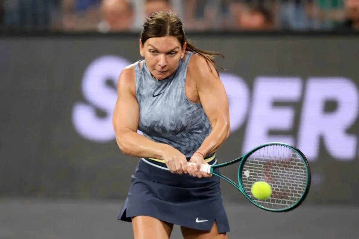 Romania's Simona Halep returns the ball during an exhibition tennis match at the 5th edition of the Sports Festival organized at the BT Arena in Cluj Napoca, Romania on June 15, 2024.   Simion Sebastian Tataru / AFP