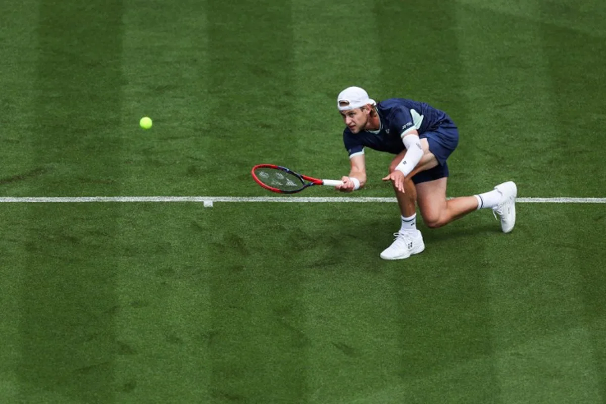 Belgium's Zizou Bergs plays a forehand return to Brazil's Joao Fonseca during their men's singles tennis match on day one at the Rothesay Eastbourne International tennis tournament in Eastbourne, southern England, on June 23, 2025. Adrian Dennis / AFP