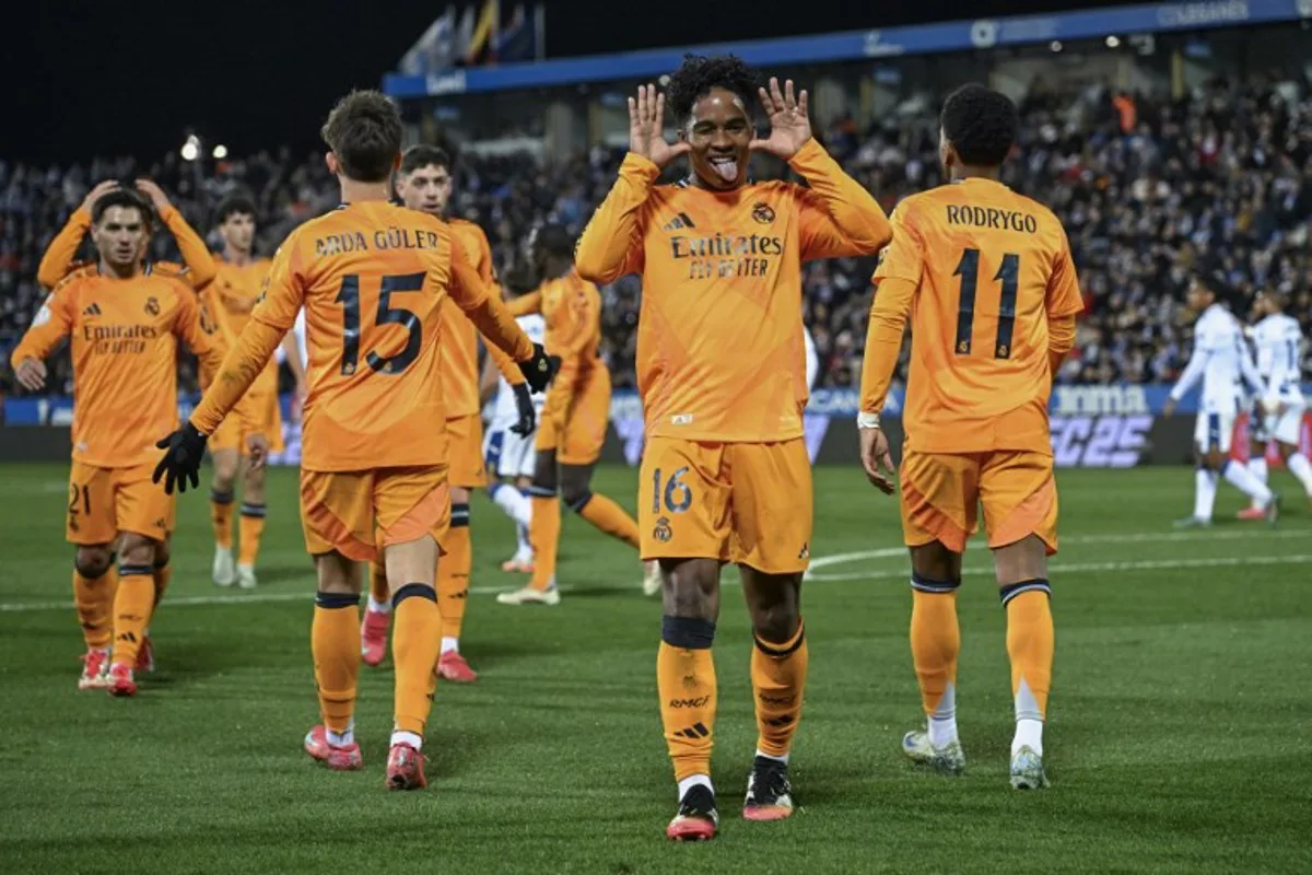 Real Madrid's Brazilian forward #16 Endrick (C) celebrates scoring their second goal during the Spanish Copa del Rey (King's Cup) quarter-final first leg football match between Club Deportivo Leganes SAD and Real Madrid CF at Butarque Municipal Stadium in Leganes on February 5, 2025.  JAVIER SORIANO / AFP