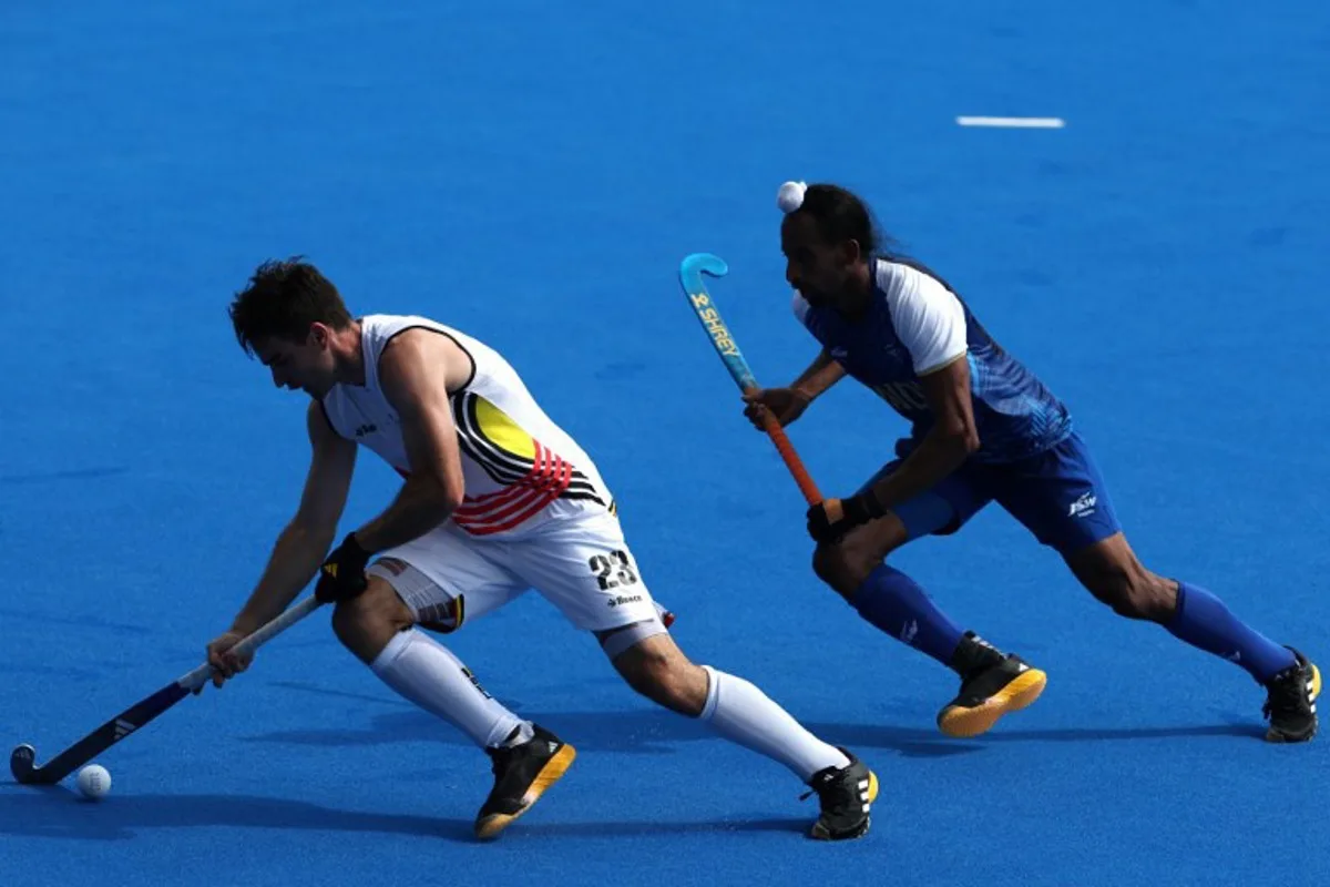 Belgium's defender #23 Arthur De Sloover is marked by India's midfielder #08 Hardik Singh in the men's pool B field hockey match between India and Belgium during the Paris 2024 Olympic Games at the Yves-du-Manoir Stadium in Colombes on August 1, 2024.  Ahmad GHARABLI / AFP