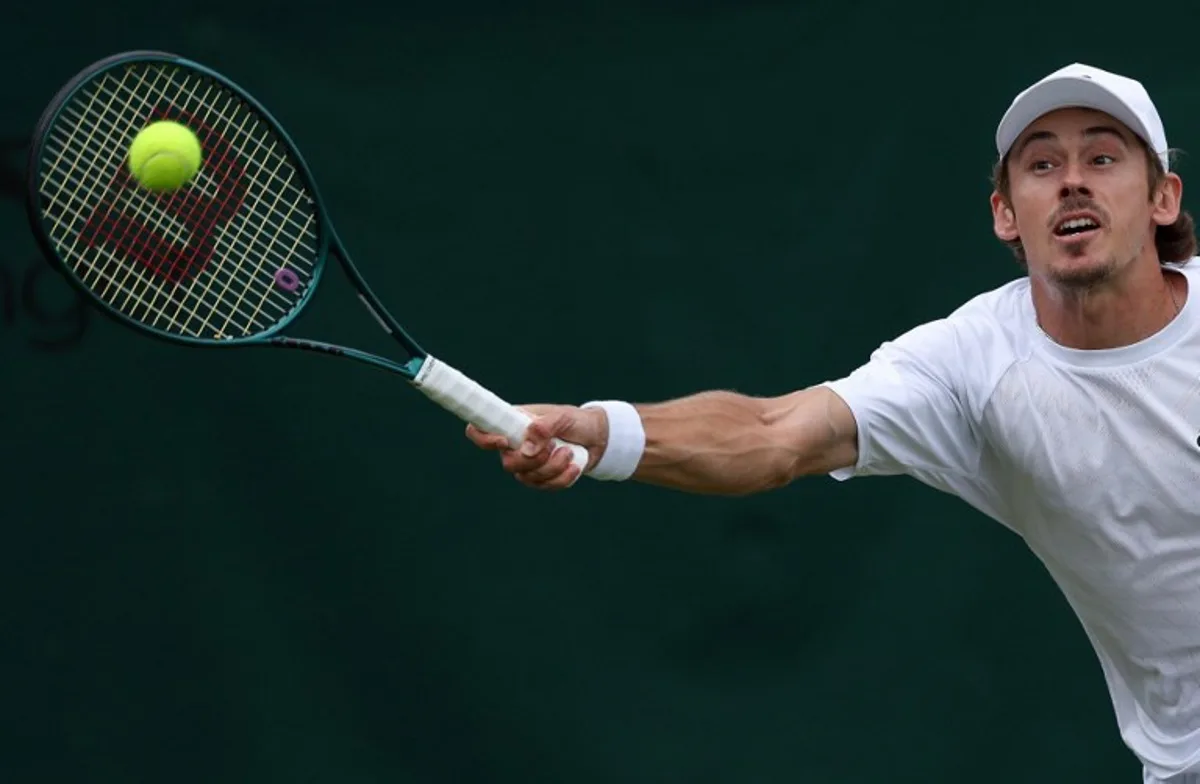 Australia's Alex De Minaur plays a forehand return to Denmark's August Holmgren during their men's singles third round tennis match on the sixth day of the 2025 Wimbledon Championships at The All England Lawn Tennis and Croquet Club in Wimbledon, southwest London, on July 5, 2025. Adrian Dennis / AFP