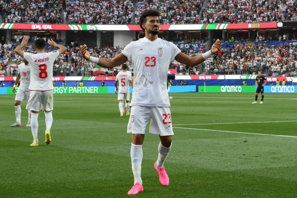 Iran's defender #23 Ramin Rezaeian celebrates scoring his team's first goal during the 2026 World Cup Group G football match between Iran and New Zealand at Los Angeles Stadium in Inglewood on June 15, 2026. Patrick T. Fallon / AFP