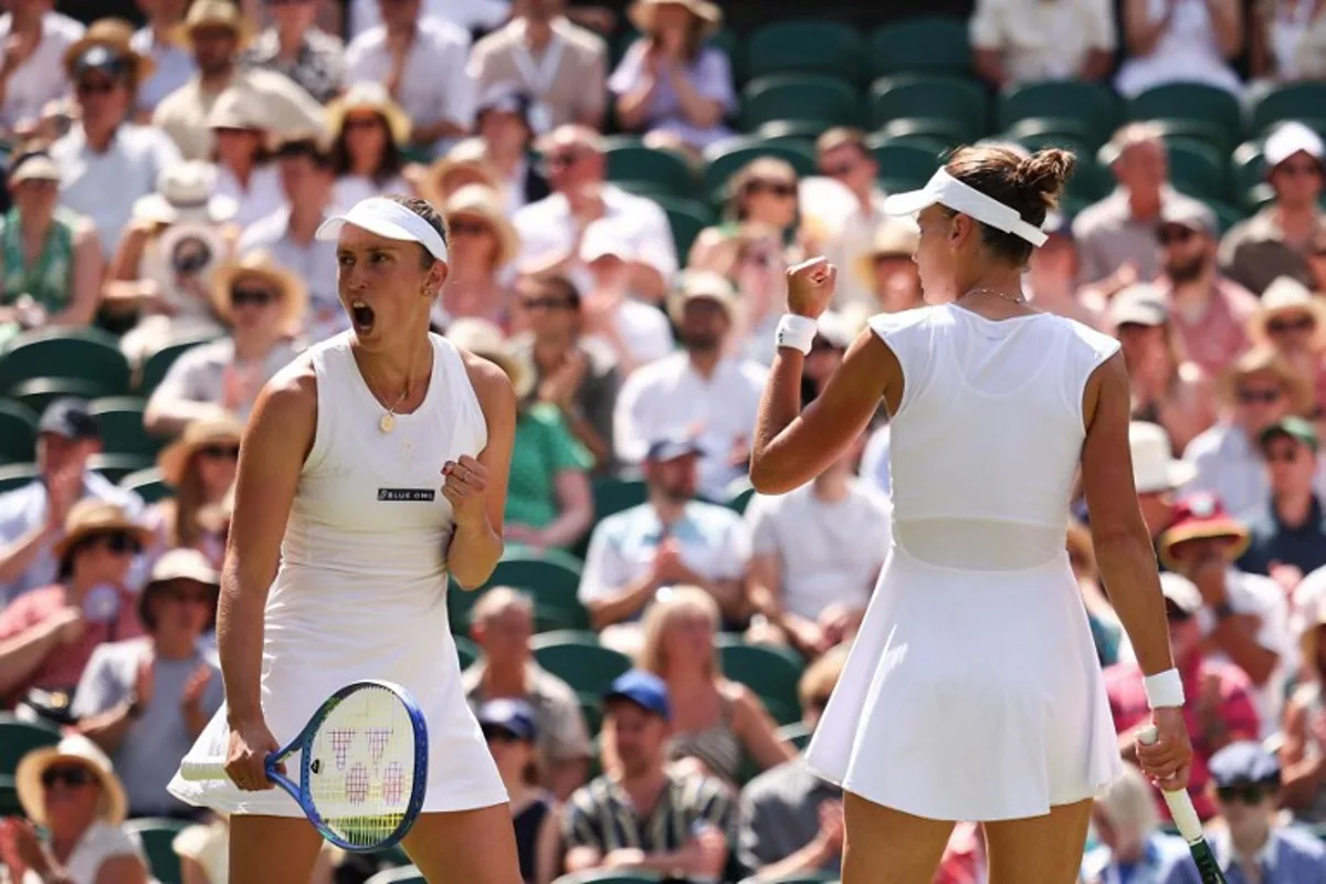 Russia's Veronika Kudermetova (R) and Belgium's Elise Mertens react after a point as they play against Taiwan's Hsieh Su-wei and Latvia's Jelena Ostapenko during their women's doubles final tennis match on the fourteenth day of the 2025 Wimbledon Championships at The All England Lawn Tennis and Croquet Club in Wimbledon, southwest London, on July 13, 2025.  HENRY NICHOLLS / AFP