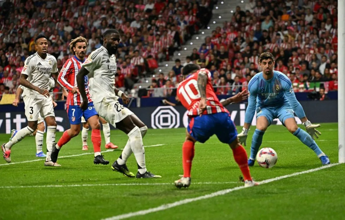 Real Madrid's Belgian goalkeeper #01 Thibaut Courtois eyes the ball during the Spanish league football match between Club Atletico de Madrid and Real Madrid CF at the Metropolitano stadium in Madrid on September 29, 2024.  JAVIER SORIANO / AFP