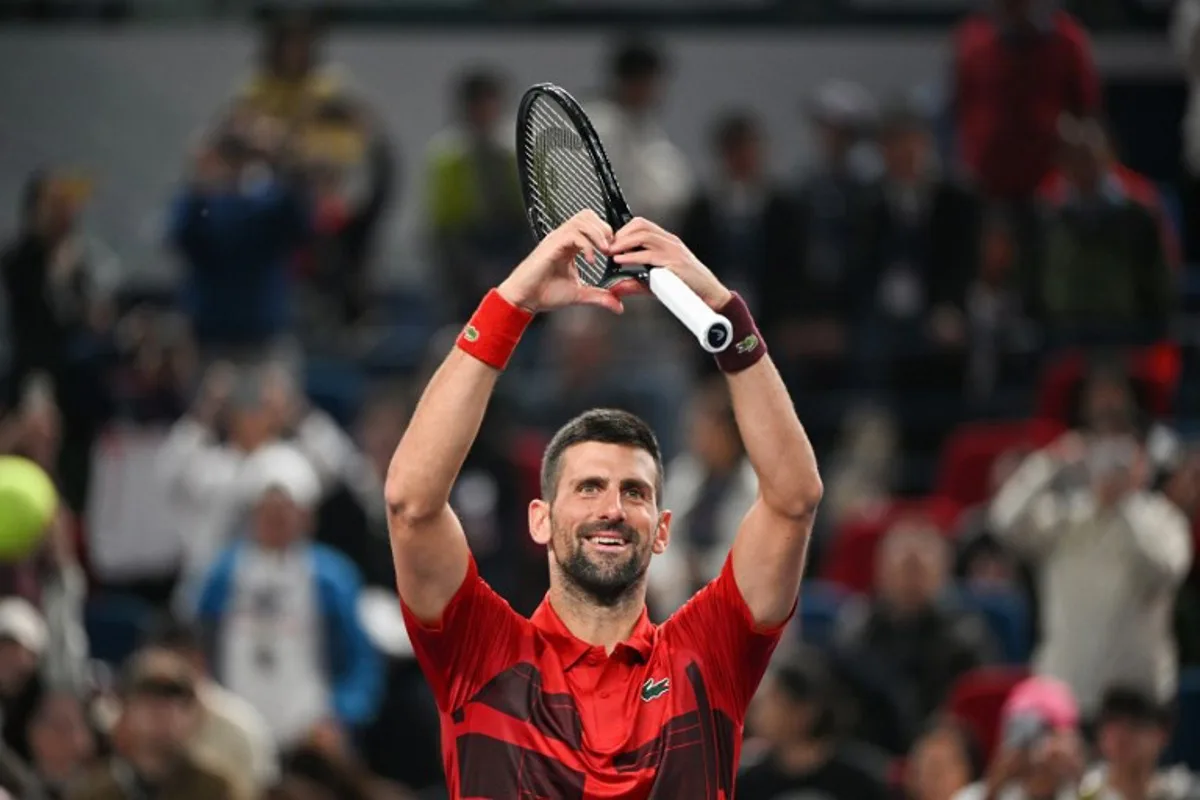 Serbia's Novak Djokovic celebrates his victory against Russia's Roman Safiullin in their men's singles match at the Shanghai Masters tennis tournament in Shanghai on October 9, 2024.  HECTOR RETAMAL / AFP