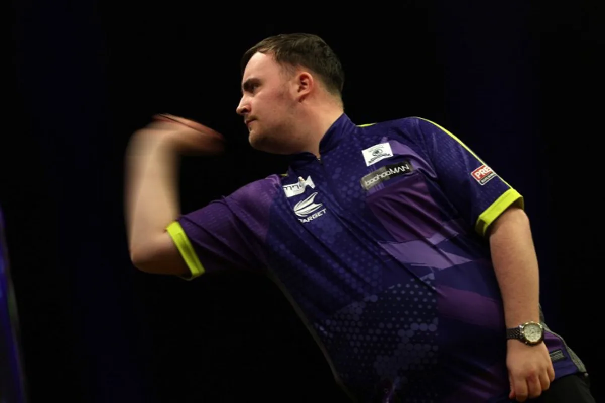 England's Luke Littler competes during his semi-final darts match against England's Michael Smith on Night 1 of the PDC Premier League, at the Utilita Arena in Cardiff, south Wales on February 1, 2024.  Adrian DENNIS / AFP