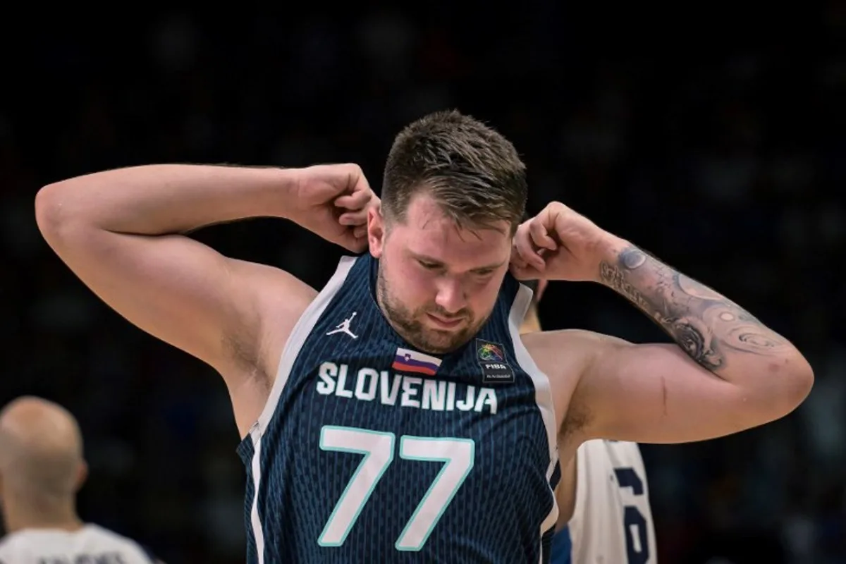 Slovenia's Luka Doncic reacts during the 2024 FIBA Olympic Qualifying Tournament semi-final basketball match between Greece and Slovenia at the Peace and Friendship Stadium in Athens, on July 6, 2024.  Aris MESSINIS / AFP