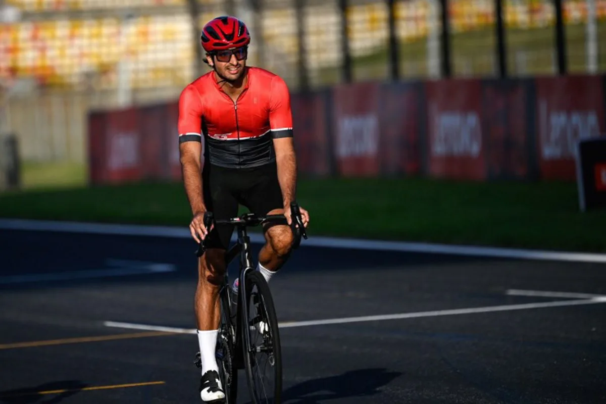 Ferrari's Spanish driver Carlos Sainz Jr rides his bike at the Shanghai International circuit ahead of the Formula One Chinese Grand Prix in Shanghai on April 18, 2024.  Pedro PARDO / AFP