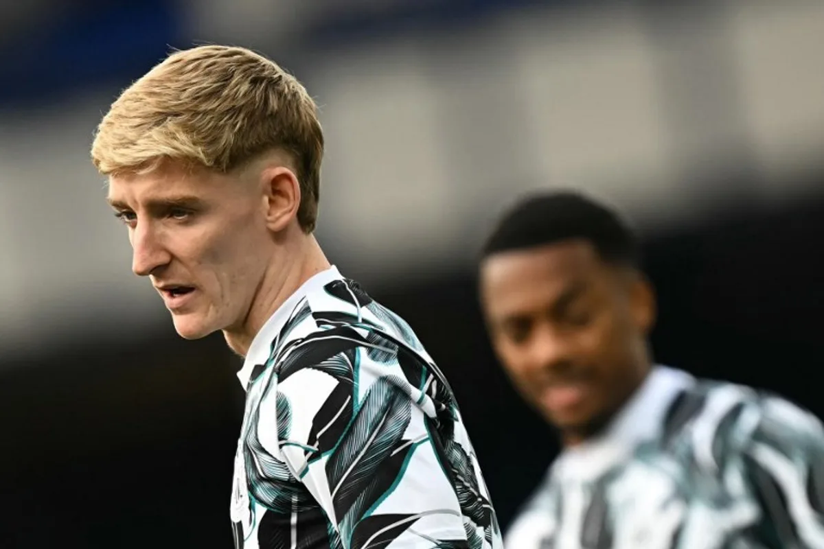 Newcastle United's English midfielder #10 Anthony Gordon warms up ahead of the English Premier League football match between Everton and Newcastle United at Goodison Park in Liverpool, north west England on October 5, 2024.  Paul ELLIS / AFP