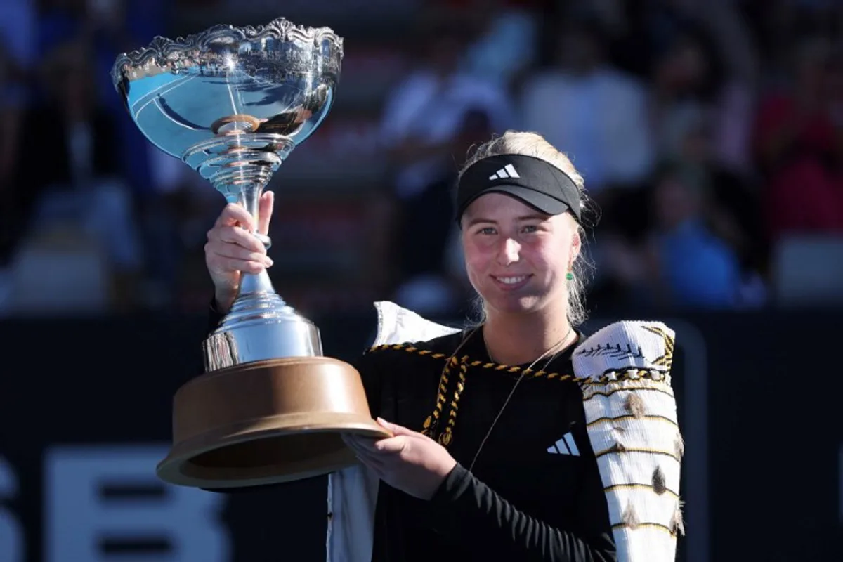 Clara Tauson of Denmark poses with the trophy as she celebrates her win over Naomi Osaka of Japan, following Osaka's retirement from their women's singles final match due to an abdominal injury, at the WTA Auckland Classic tennis tournament in Auckland on January 5, 2025.  Michael Bradley / AFP