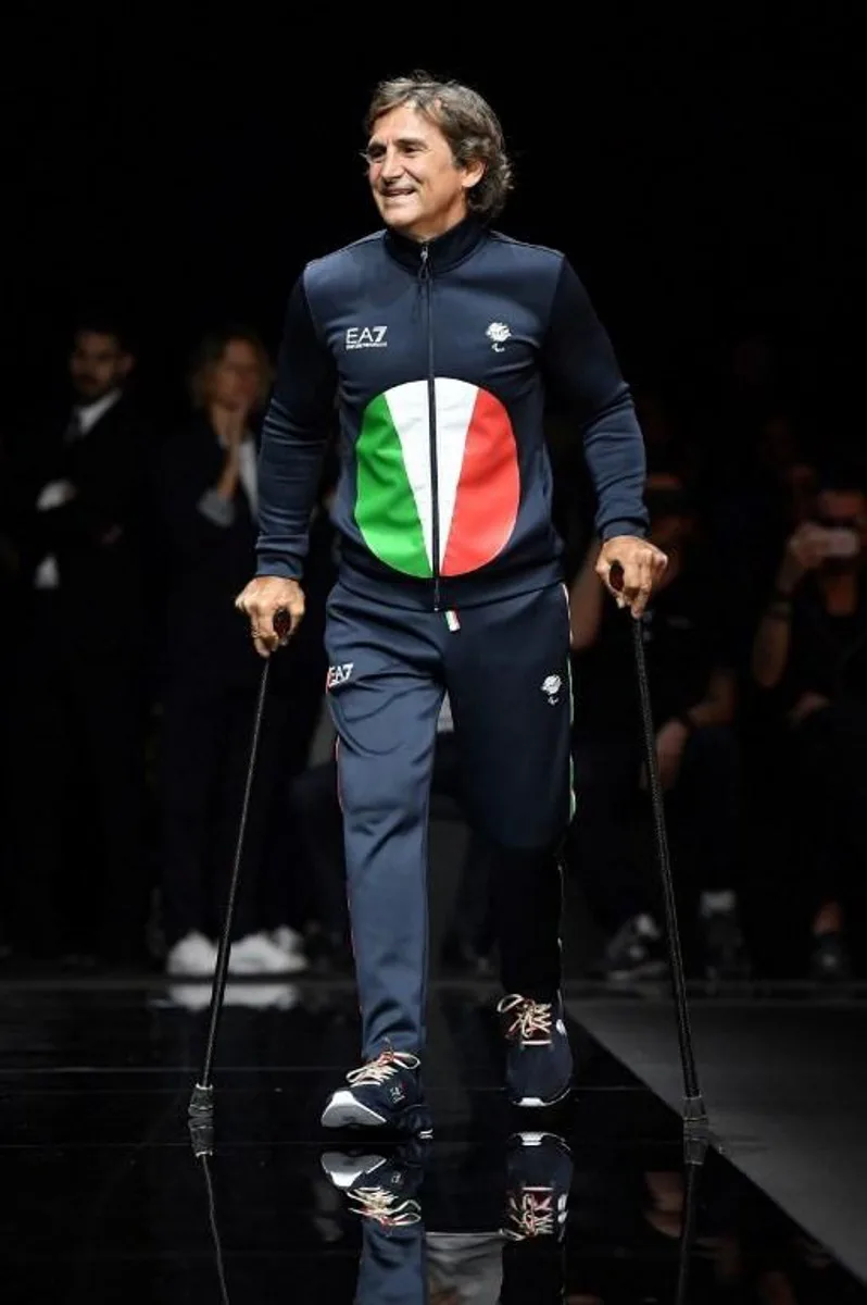 Italian professional racing driver and paracyclist, Alessandro Zanardi presents a creation for fashion house Emporio Armani during the presentation of its men's spring/summer 2020 fashion collection in Milan on June 15, 2019.   Marco Bertorello / AFP