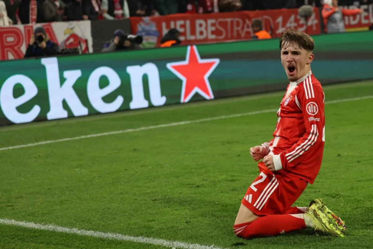 Bayern Munich's German midfielder #42 Lennart Karl celebrates scoring his team's second goal 2:1 during the UEFA Champions League, league phase - day 6 football match between Bayern Munich and Sporting CP in Munich, southern Germany, on December 9, 2025. Alexandra BEIER / AFP