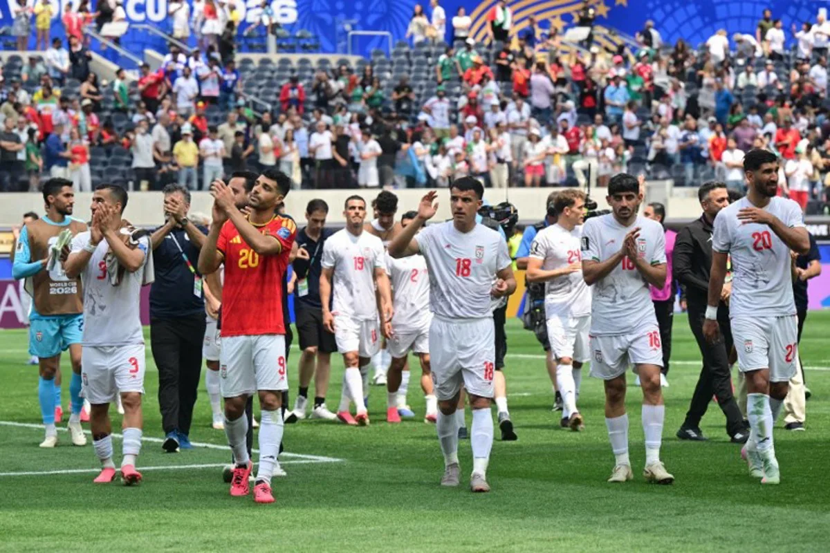Iran's players celebrate at the end of the 2026 World Cup Group G football match between Belgium and Iran at the Los Angeles Stadium in Inglewood on June 21, 2026.   Frederic J. Brown / AFP
