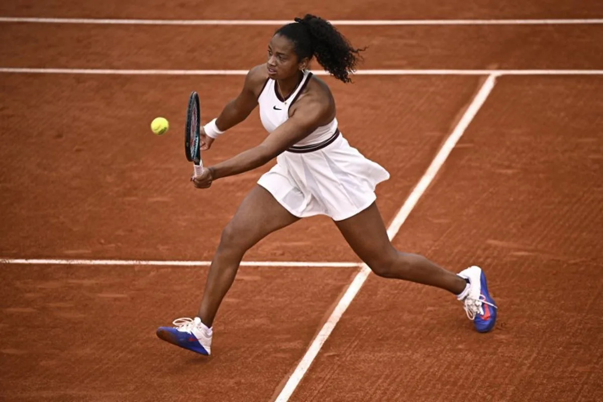 US Robin Montgomery plays a forehand return to France's Diane Parry during their women's singles match on day 2 of the French Open tennis tournament at the Roland-Garros Complex in Paris on May 26, 2025. JULIEN DE ROSA / AFP