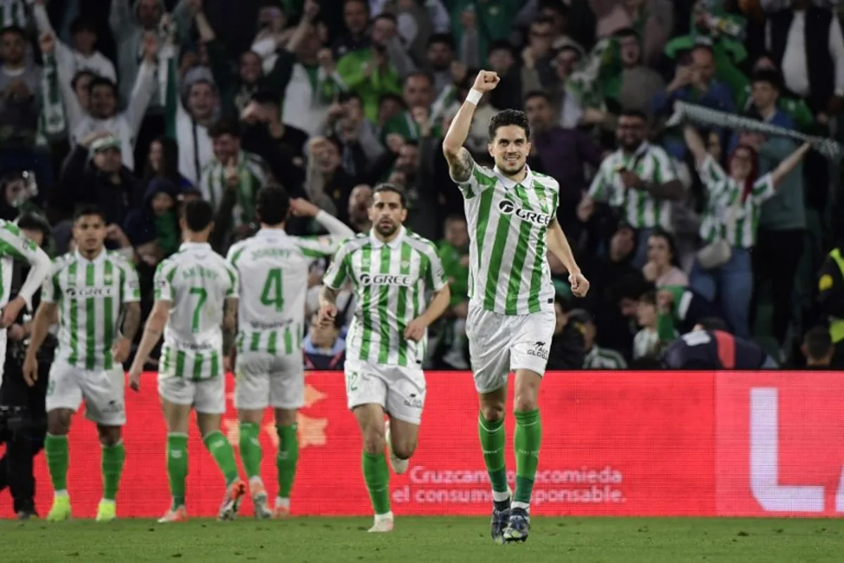 Real Betis' US midfielder #04 Johnny Cardoso celebrates scoring an equalizing goal during the Spanish league footbal match between Real Betis and Real Madrid CF at Benito Villamarin Stadium in Seville on March 1, 2025.  CRISTINA QUICLER / AFP