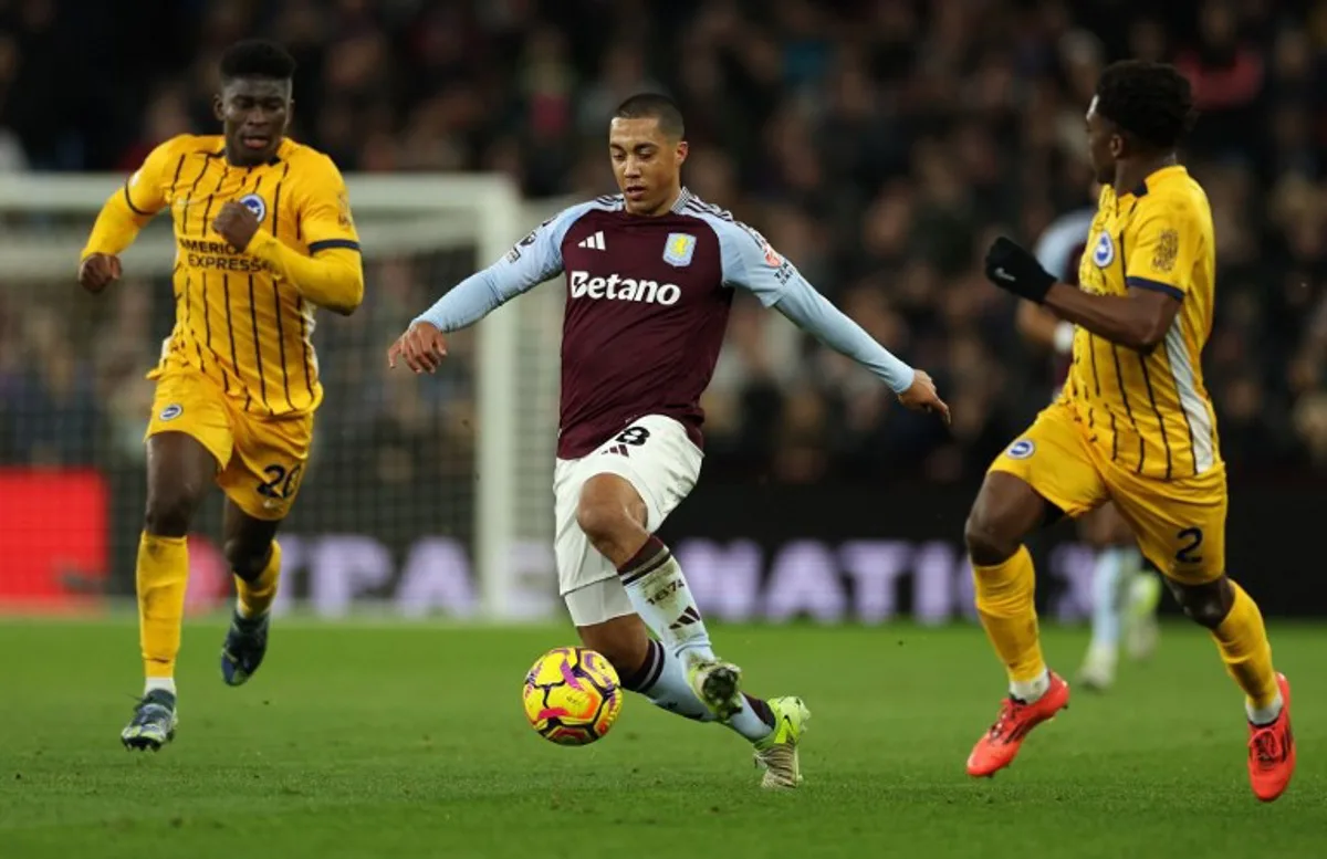 Aston Villa's Belgian midfielder #08 Youri Tielemans (C) runs with the ball during the English Premier League football match between Aston Villa and Brighton and Hove Albion at Villa Park in Birmingham, central England on December 30, 2024.  Adrian Dennis / AFP