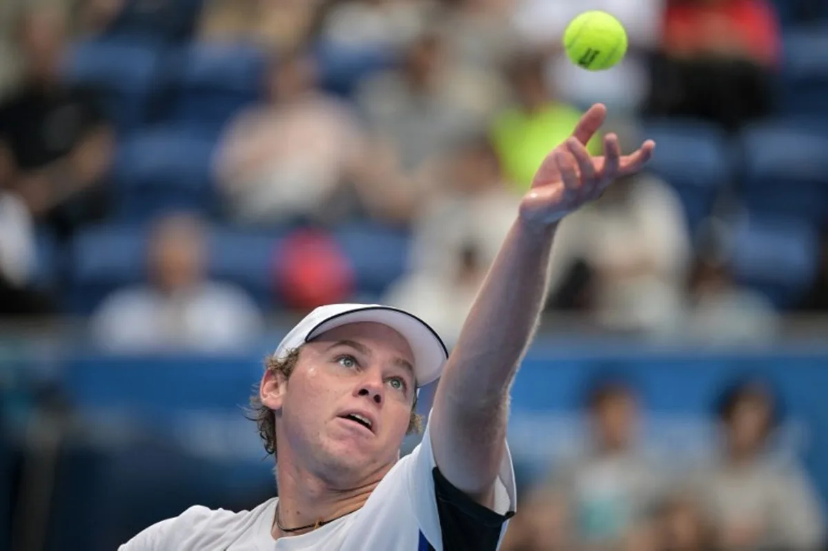 Alex Michelsen of the US serves against Tomas Machac of the Czech Republic during their men's singles quarter-final match on the fifth day of the ATP Japan Open tennis tournament in Tokyo on September 29, 2024.  Richard A. Brooks / AFP