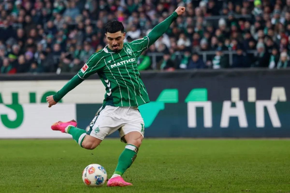 Bremen's Spanish midfielder #18 Cameron Puertas shoots during the German first division Bundesliga football match between SV Werder Bremen and FC Bayern Munich in Bremen, northern Germany February 14, 2026. Focke Strangmann / AFP