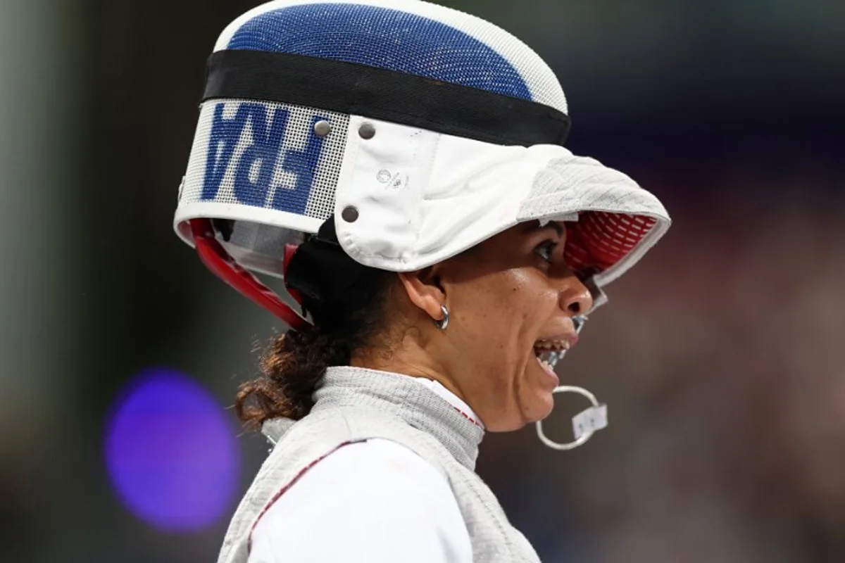 France's Ysaora Thibus reacts as she competes against Canada's Yunjia Zhang in the women's foil team round of 8 bout during the Paris 2024 Olympic Games at the Grand Palais in Paris, on August 1, 2024. Franck FIFE / AFP