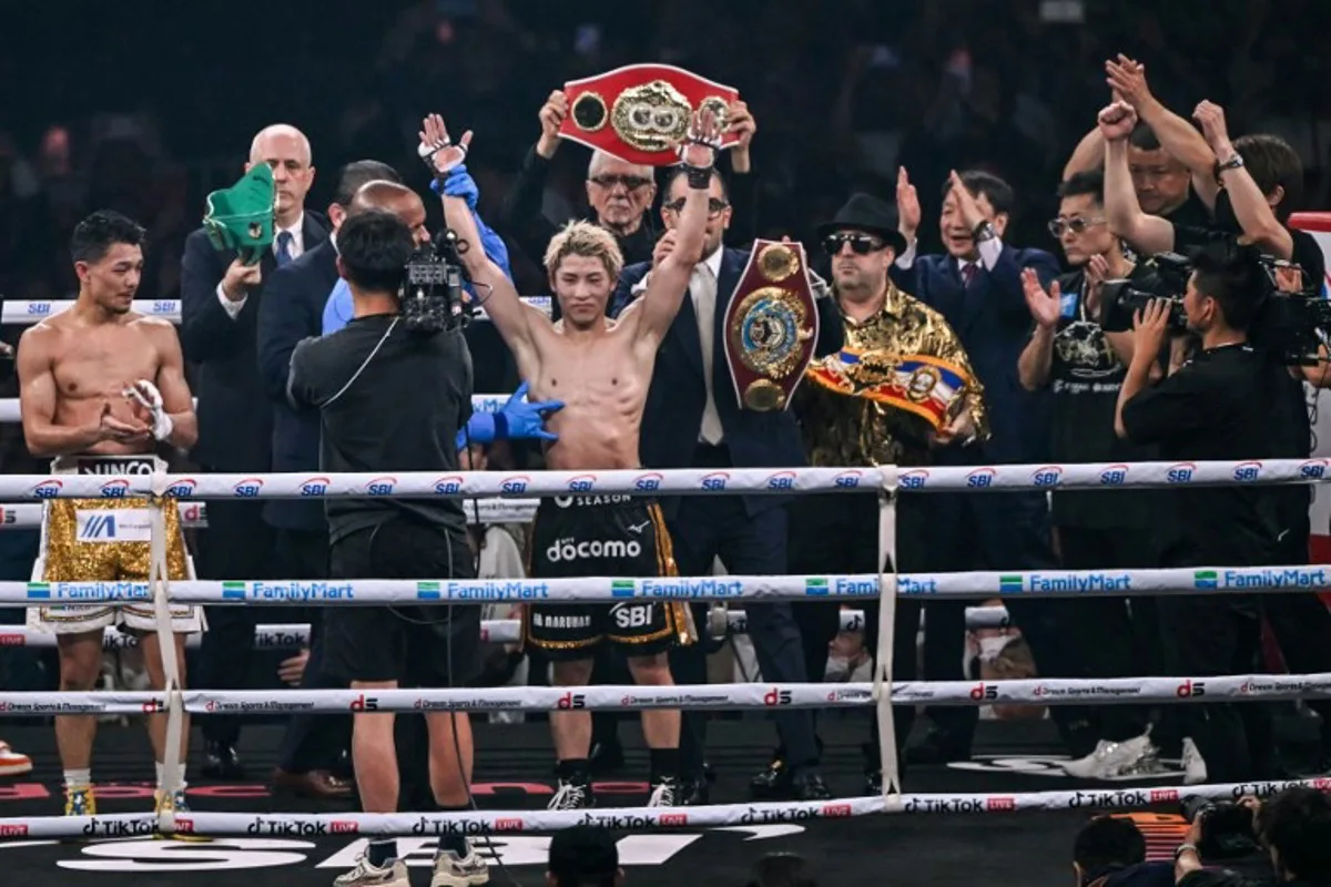 Naoya Inoue (C) celebrates defeating Junto Nakatani in their super bantamweight championship boxing contest at Tokyo Dome in Tokyo on May 2, 2026.  Yuichi YAMAZAKI / AFP