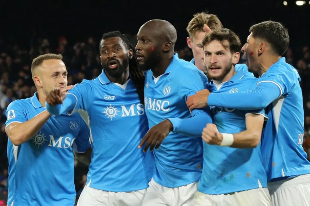 Napoli's Belgian forward #11 Romelu Lukaku (C) celebrates scoring his team's first goal with teammates during the Italian Serie A football match between Napoli and Roma at the Diego Armando Maradona stadium in Naples on November 24, 2024.  Carlo Hermann / AFP