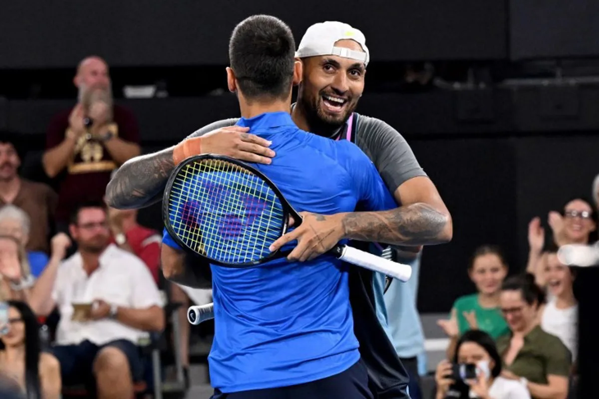 Novak Djokovic of Serbia (L) and doubles partner Nick Kyrgios of Australia (R) celebrate winning their men's doubles match against Alexander Erler of Austria and Andreas Mies of Germany at the Brisbane International tennis tournament in Brisbane on December 30, 2024.  William WEST / AFP