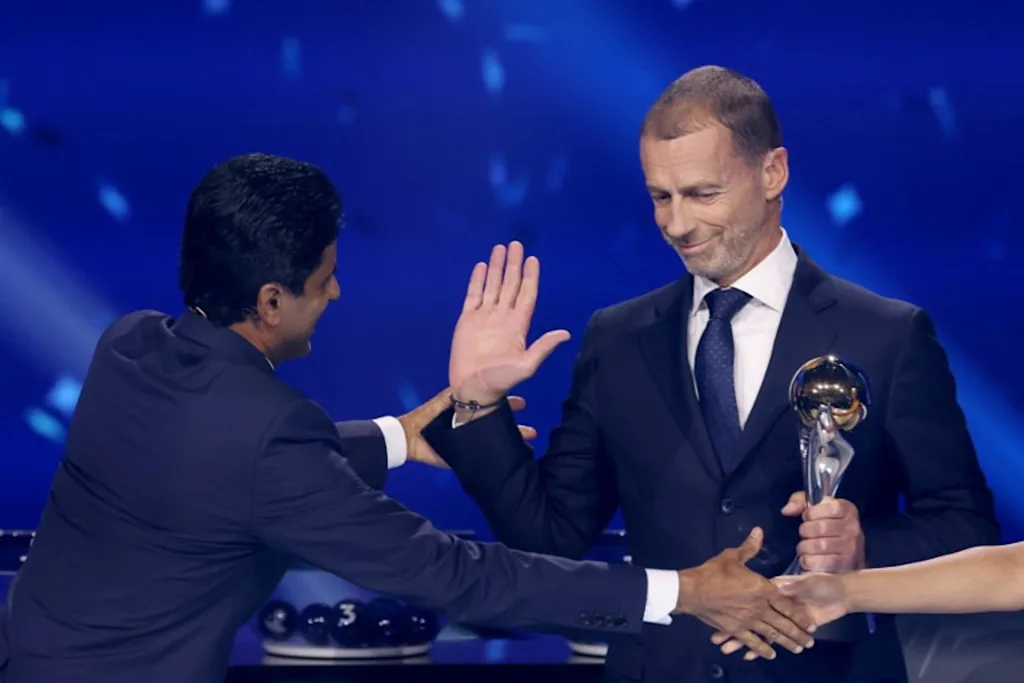 Paris Saint Germain's Qatari president Nasser al-Khelaifi (L) receives UEFA Respect Award from UEFA President Aleksander Ceferin during the draw ceremony for the league phase of the 2026-2027 UEFA Champions League football tournament at the Grimaldi Forum in the Principality of Monaco on August 27, 2026.  Valery HACHE / AFP